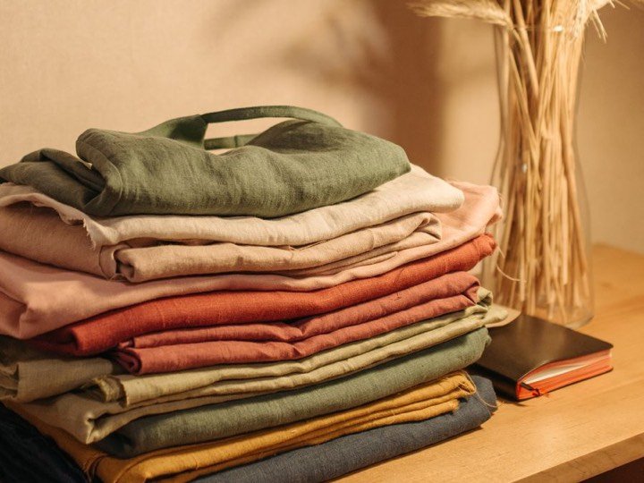 A stack of neatly folded clothing in warm colors
